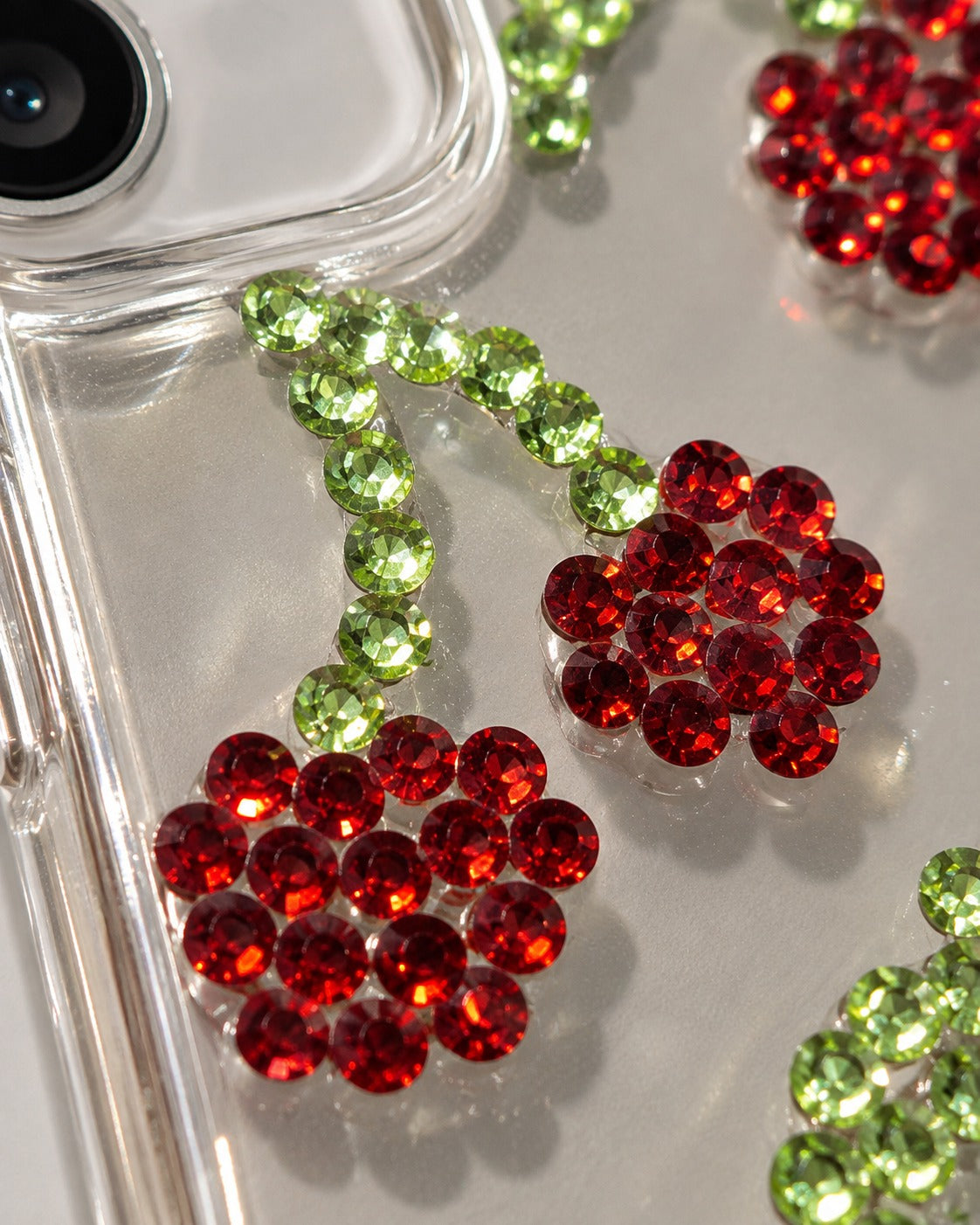 Macro of red and green rhinestone cherries