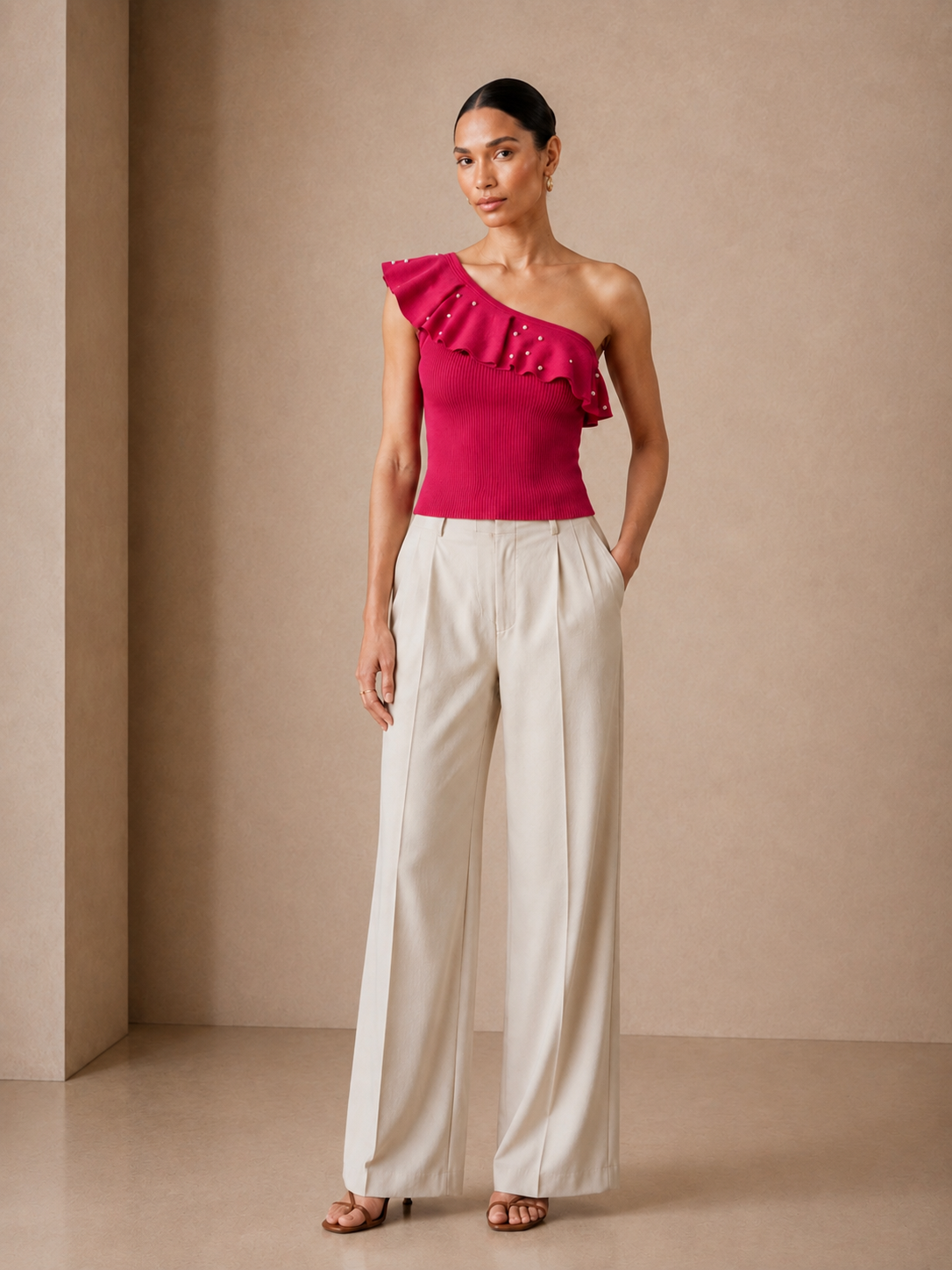 Pearl Ruffle One-Shoulder Knit in fuchsia worn with wide cream trousers