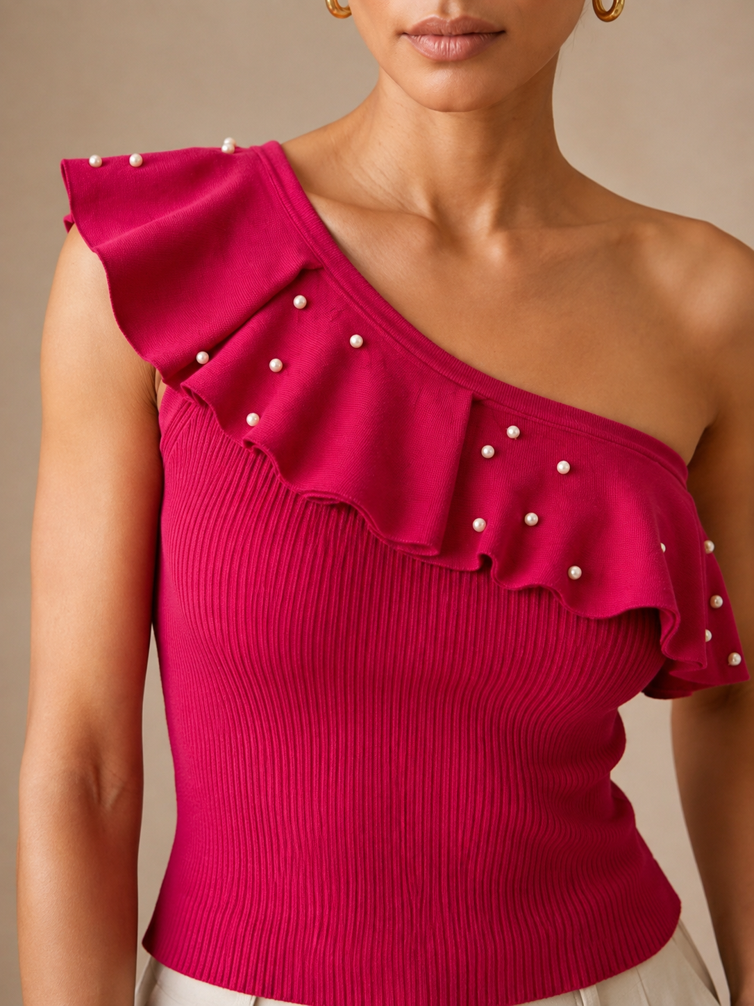 Close detail of the pearl-scattered asymmetric ruffle